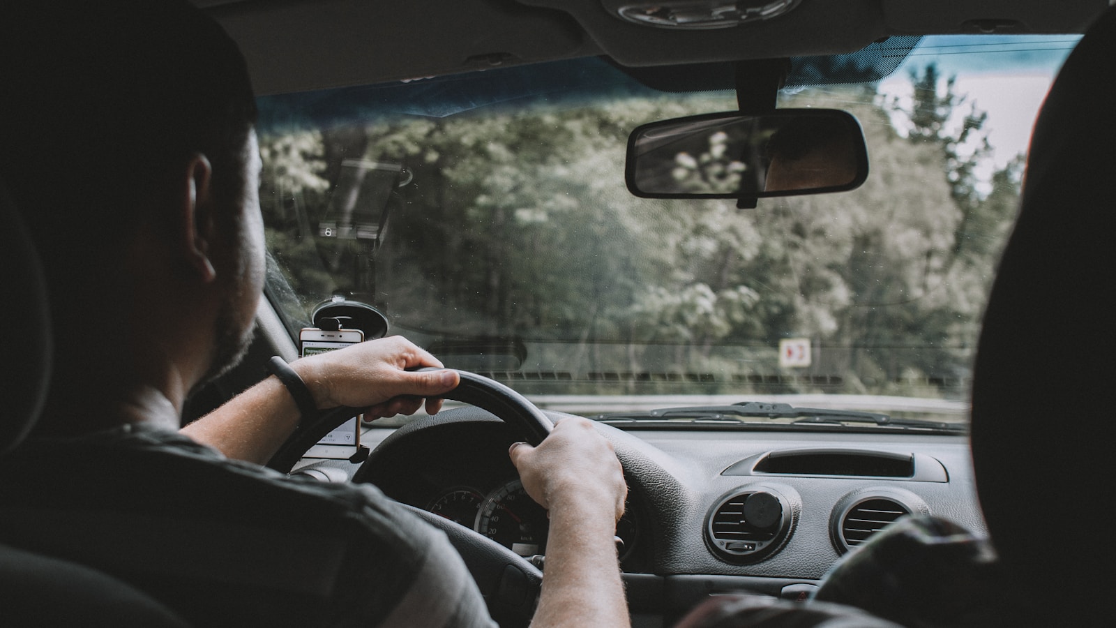 person driving auto during daytime